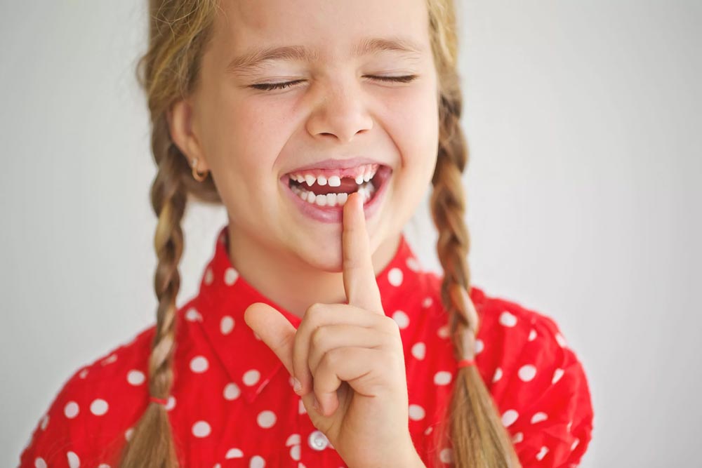 Girl is losing her baby teeth