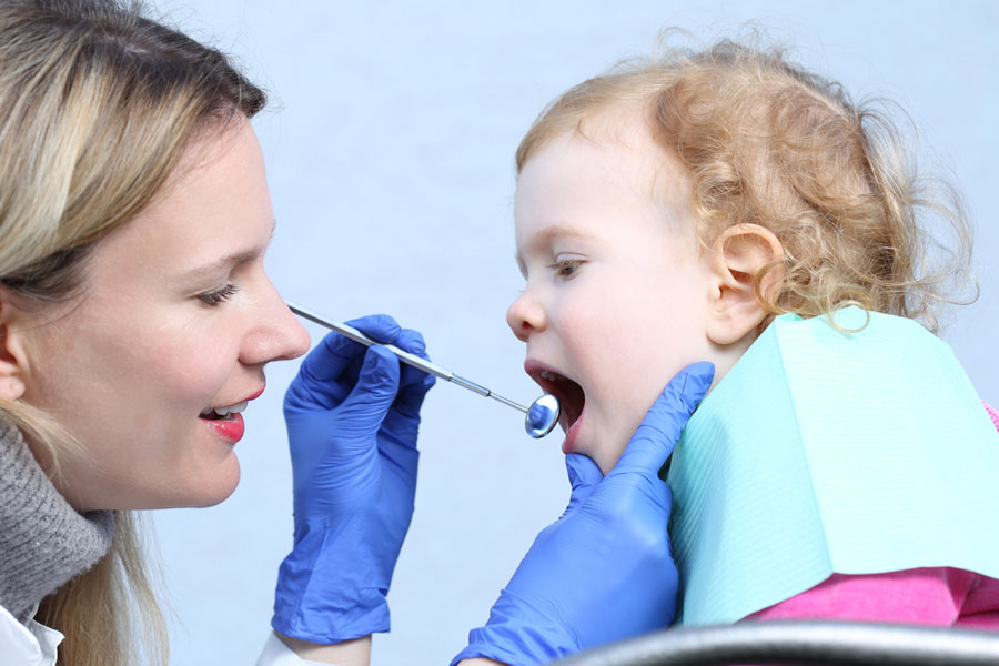 a dentist treating a child