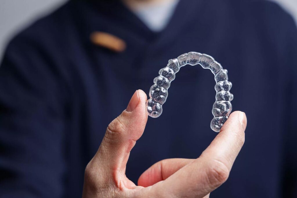 doctor holding invisalign