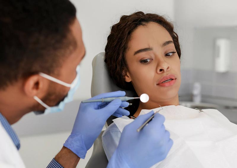 Woman being afraid of dental instrument