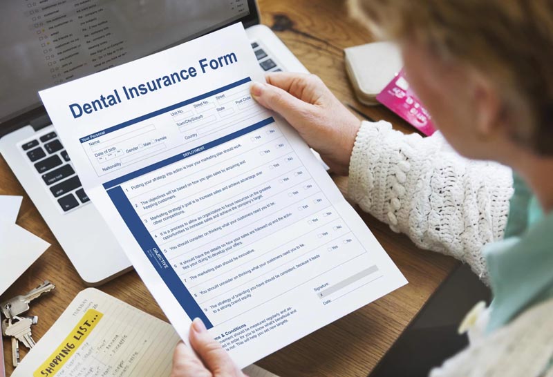 Woman checking her dental insurance form