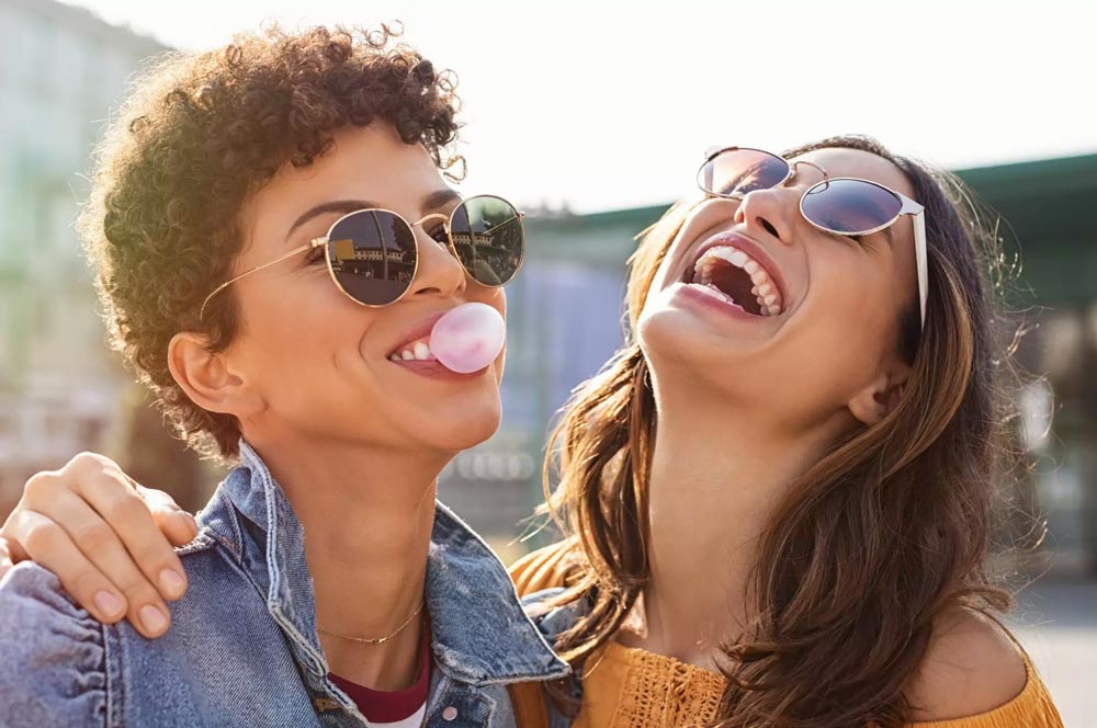 two women's in glares laughing