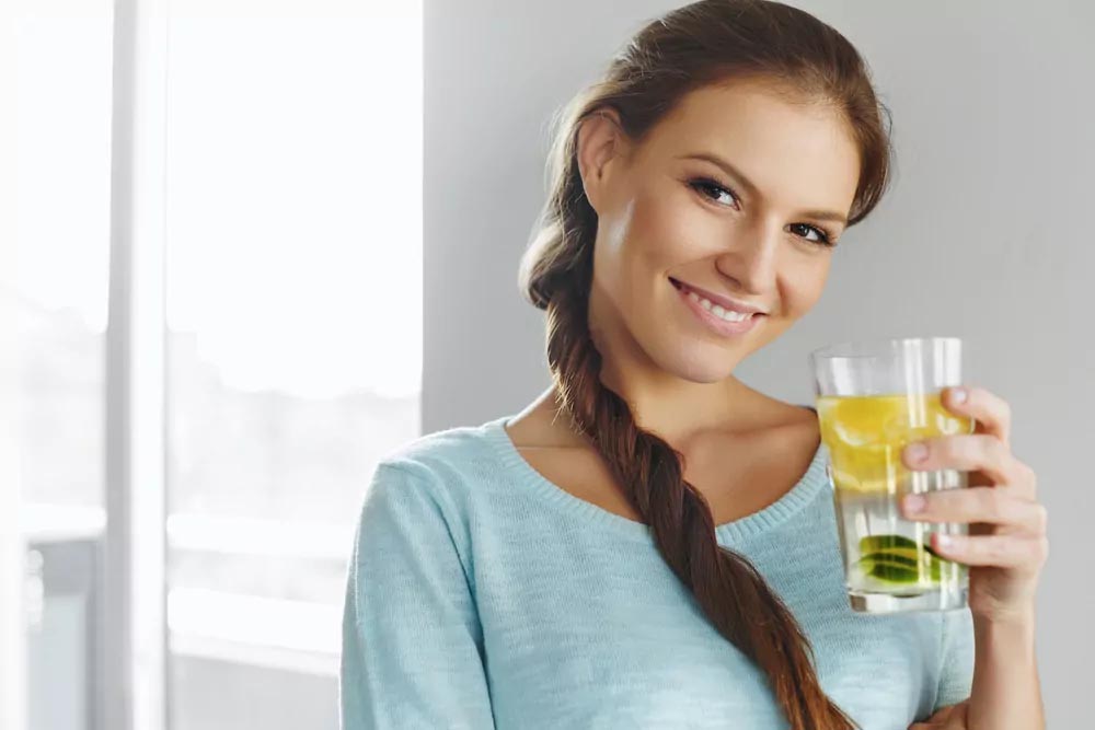 Woman holding lemon juice