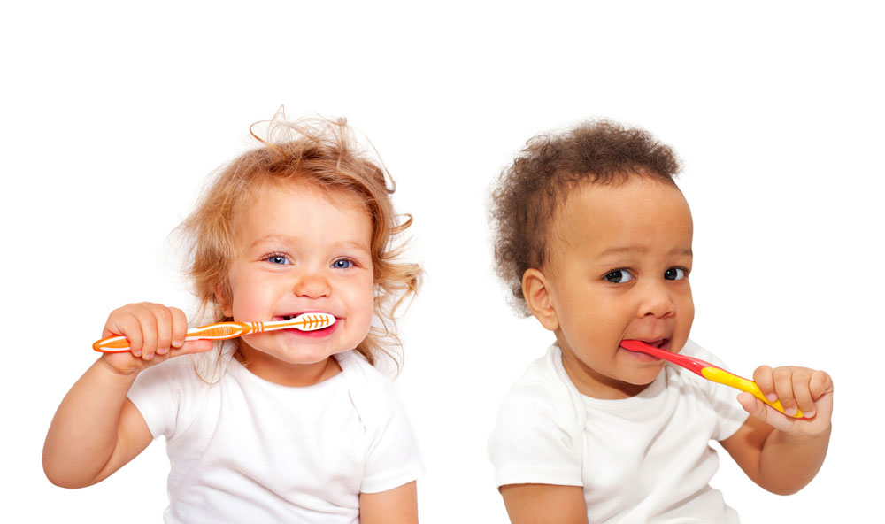 two kids brushing their teeth