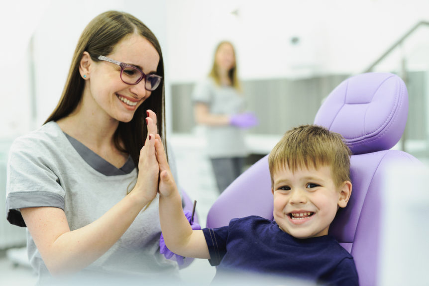 a dentist playing with a child