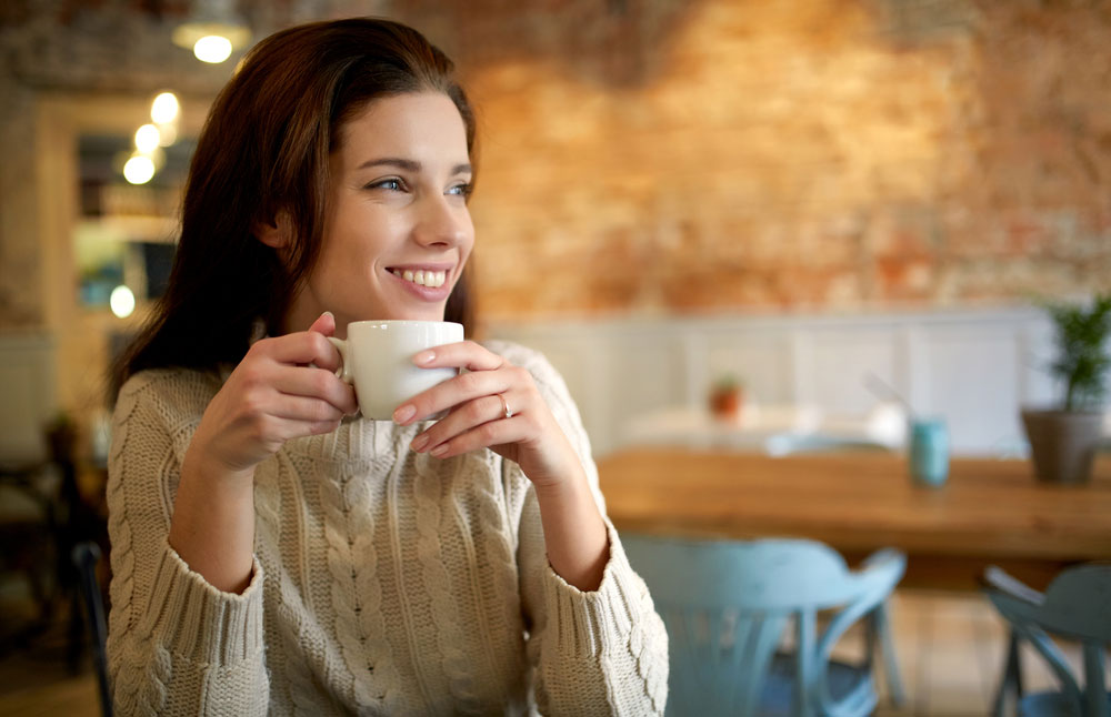 a woman drinking coffee