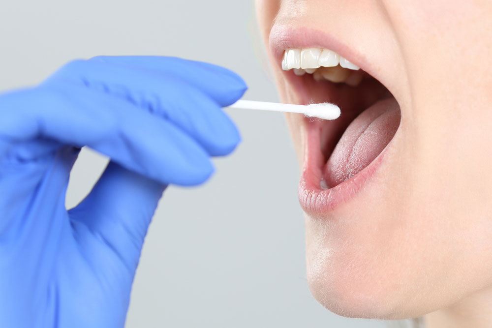 a dentist testing a patient's saliva
