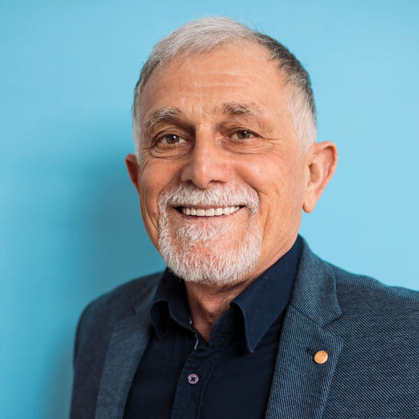 confident and smiling senior man on blue background