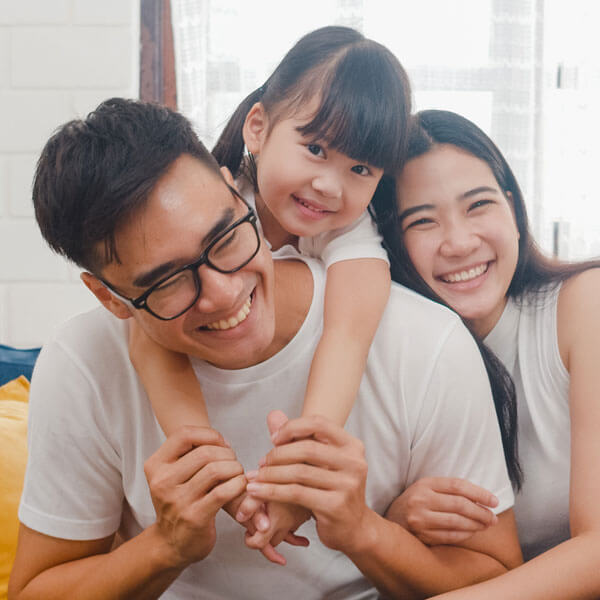 happy, cheerful family on couch laughing and smiling