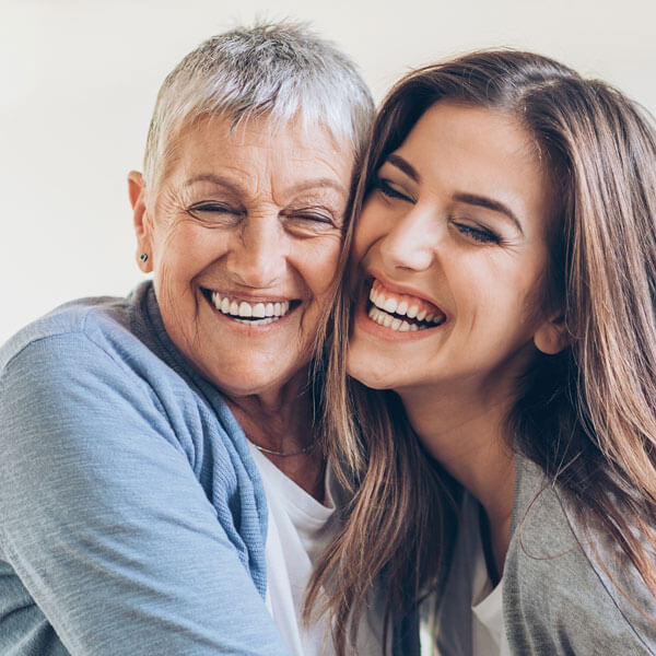 Happy adult mother and daughter embracing
